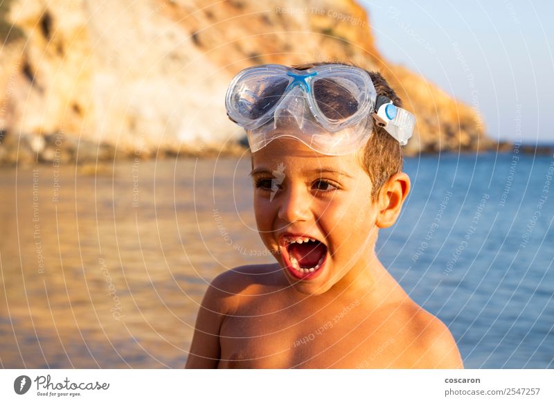 Kid with diving goggles on the shore of the ocean Lifestyle Joy Happy Relaxation Swimming pool Leisure and hobbies Vacation & Travel Summer Beach Ocean Sports