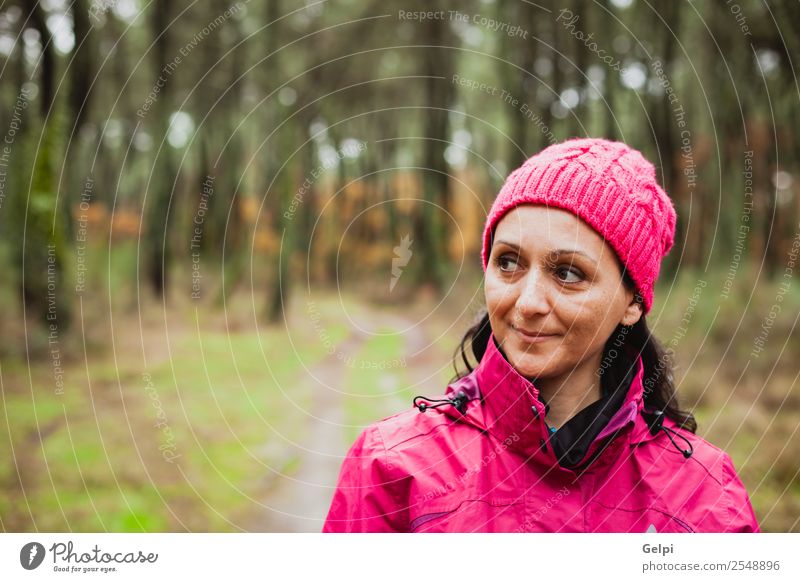 Matured woman Lifestyle Beautiful Freedom Winter Hiking Human being Woman Adults Nature Autumn Tree Leaf Park Forest Lanes & trails Fashion Hat Brunette Long