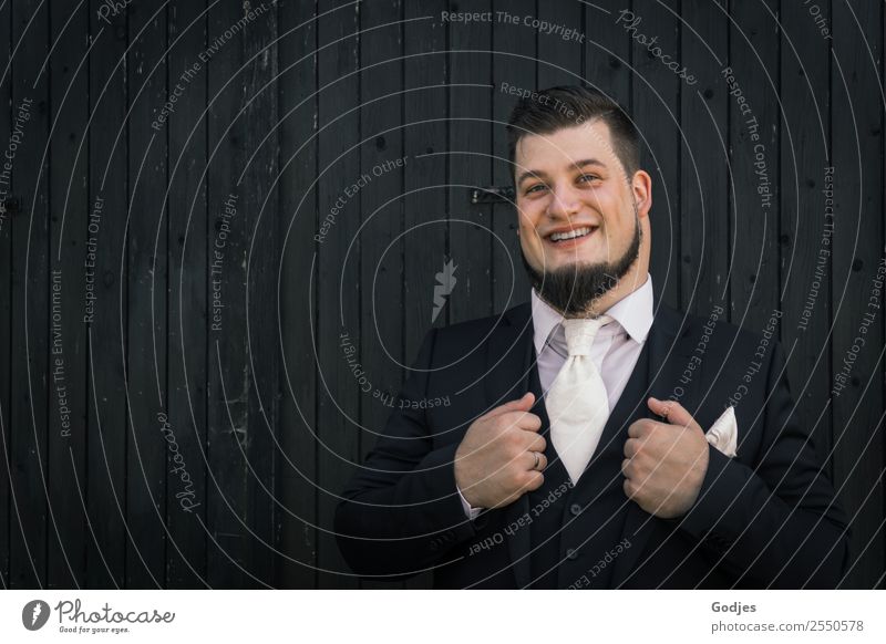 Groom I: Man stands in front of wooden wall Masculine Young man Youth (Young adults) Adults 1 Human being 18 - 30 years To hold on Smiling Stand Authentic