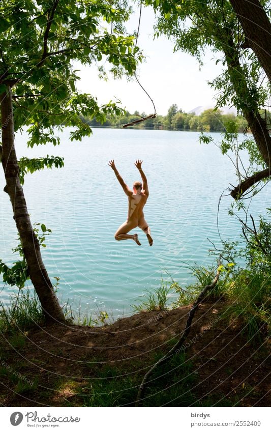 Bathing fun at the quarry pond. Young naked man jumps joyfully into the water bathing fun Joy Holiday at home Naked Leisure and hobbies Young man Freedom Summer