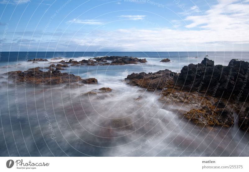 flow changes Landscape Water Sky Clouds Horizon Summer Beautiful weather Coast Ocean Movement Blue Brown Loneliness Eternity Rock Cliff Colour photo