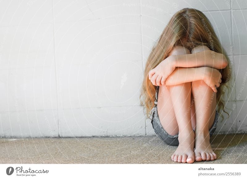 sad little girl sitting near the wall Face Child Human being Woman Adults Family & Relations Infancy Think Sadness White Emotions Concern Grief Fatigue Pain