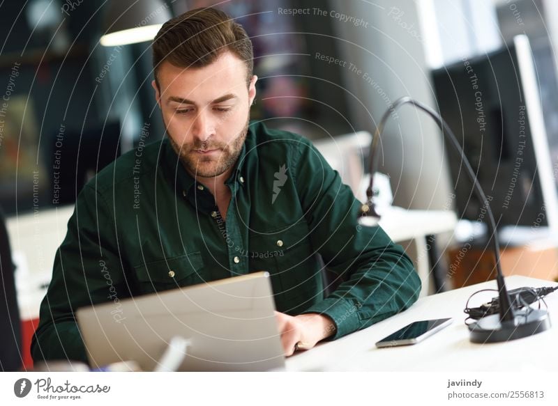 Young man studying with laptop computer on white desk. Lifestyle School Study Academic studies Work and employment Business Computer Notebook Technology