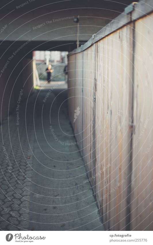 site fence Exterior shot Day Shallow depth of field Pedestrian underpass Central perspective Wooden fence Hoarding Footpath Building line Vanishing point