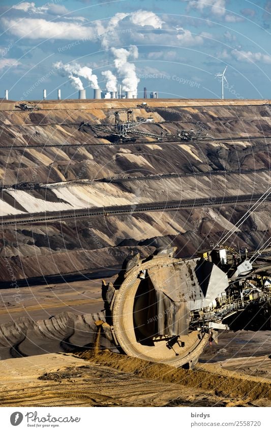 Poisoning the climate, bucket-wheel excavators in the Garzweiler 2 open-cast lignite mine, coal-fired power plant in the background Energy industry