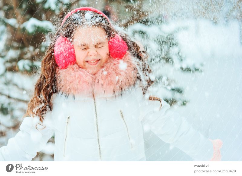 Winter portrait of happy kid girl walking outdoor Joy Happy Vacation & Travel Adventure Freedom Snow Child Infancy Nature Snowfall Park Clothing To enjoy