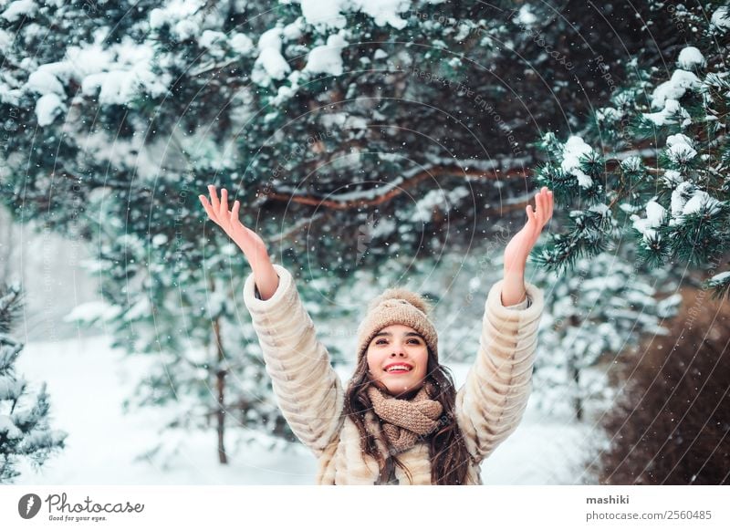 happy woman catching snowflakes in snowy winter forest Style Joy Happy Face Make-up Lipstick Knit Vacation & Travel Winter Snow Feminine Woman Adults Nature