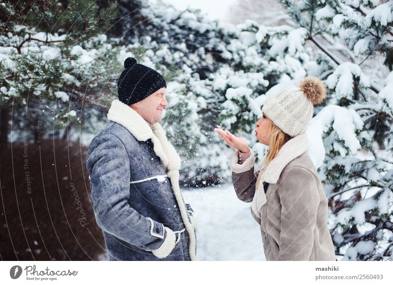 winter portrait of happy couple playing in snowy forest Lifestyle Joy Vacation & Travel Adventure Freedom Winter Snow Woman Adults Man Couple Nature Snowfall