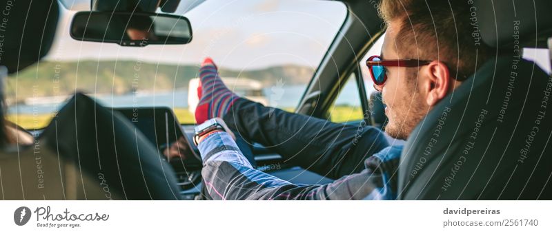 Young man resting feet up sitting on the car Lifestyle Joy Happy Relaxation Leisure and hobbies Vacation & Travel Trip Adventure Human being Man Adults Coast