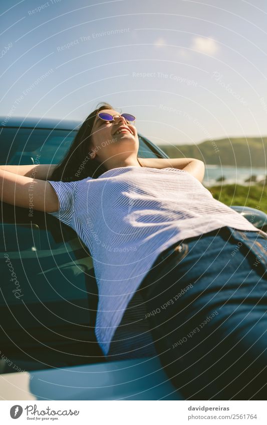 Young girl lying on the windshield Lifestyle Style Happy Beautiful Relaxation Calm Vacation & Travel Sunbathing Ocean Human being Woman Adults