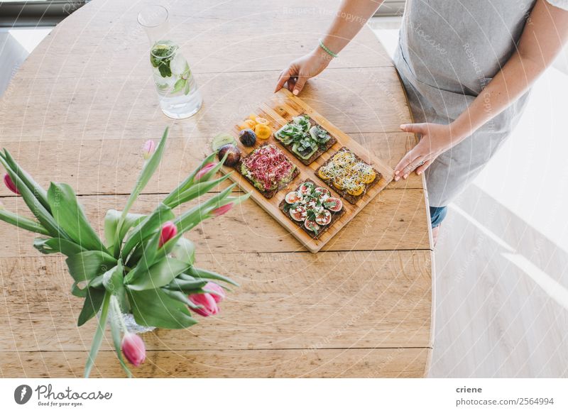 young woman serving delicious bread with vegetables on table Bread Eating Breakfast Lunch Diet Bottle Lifestyle Style Decoration Table Kitchen Hand Flower Wood