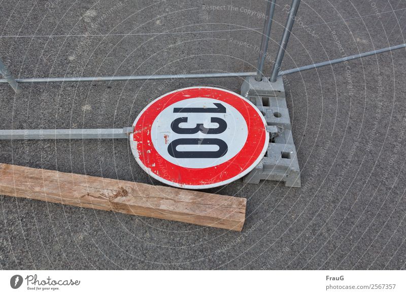 upside-down world... Fence Road sign Wood Metal Lie Asphalt Hoarding Speed limit regulatory character Broken 130 Colour photo Exterior shot Downward