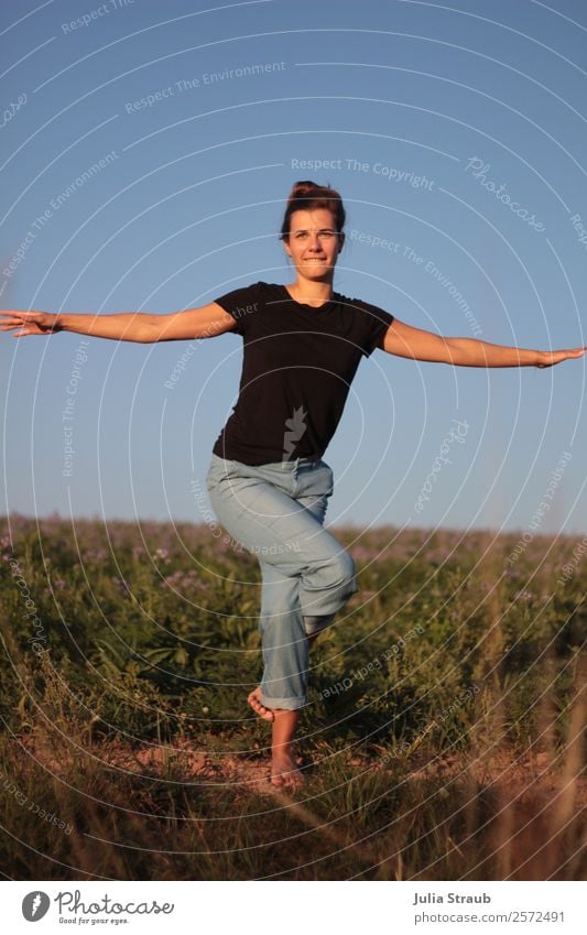 Pretty woman doing yoga practice on a field Yoga Feminine Woman Adults 1 Human being 30 - 45 years Sunlight Summer Beautiful weather flowers Grass Meadow Field