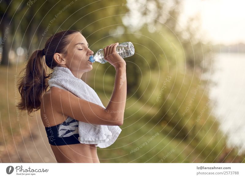 Fit sporty woman drinking water from a bottle Bottle Sports Woman Adults 1 Human being 18 - 30 years Youth (Young adults) Park Fitness Athletic training young