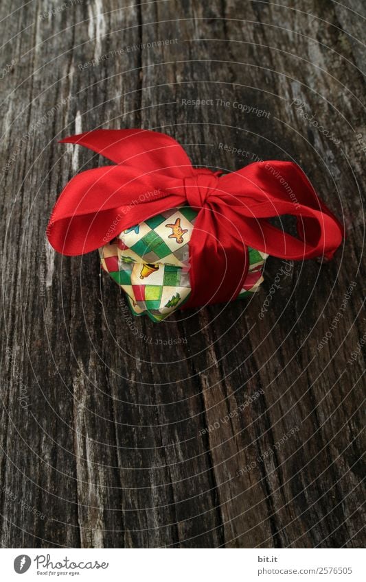 colourful christmas parcels packed with christmas paper with red bow, on rustic wood. Christmas presents, lie nicely decorated with ribbon on wooden table. Many Christmas parcels wrapped with wrapping paper with Christmas motif. Concept gifts Advent.