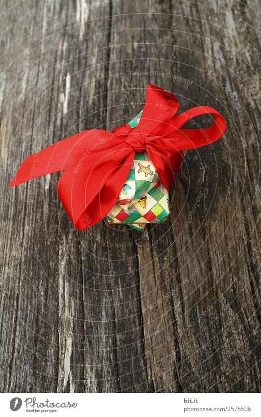 colourful christmas parcels packed with christmas paper with red bow, on rustic wood. Christmas presents, lie nicely decorated with ribbon on wooden table. Many Christmas parcels wrapped with wrapping paper with Christmas motif. Concept gifts Advent.