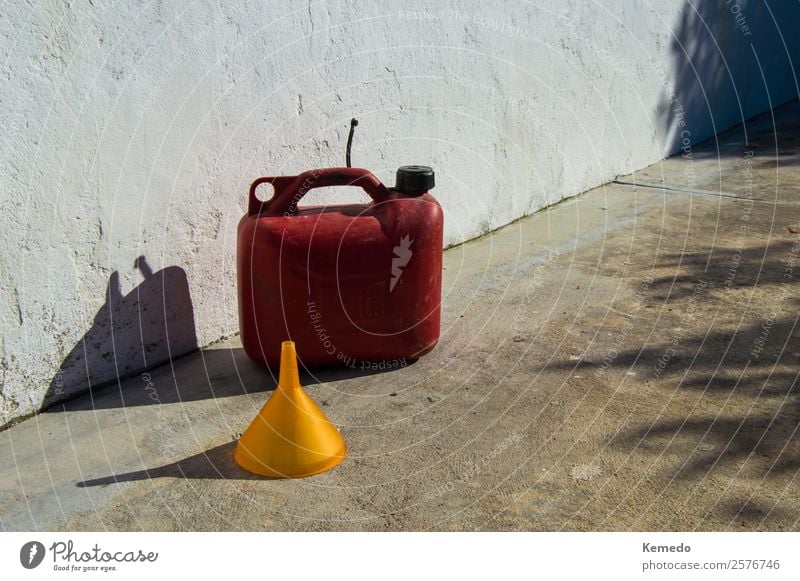 Red gasoline jerrycan of five liters and a yellow funnel. Lifestyle Handicraft Camping Summer Sun Mountain Living or residing House (Residential Structure)