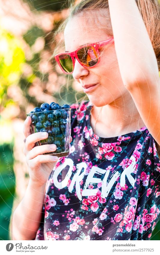 Happy girl enjoying eating the fresh blueberries Food Fruit Nutrition Eating Vegetarian diet Diet Glass Lifestyle Summer Human being Young woman