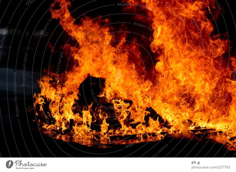 Put out the fire on us Smoke Aggression Esthetic Threat Dark Authentic Hot Warmth Yellow Red Fire Blaze Trash container Burn burning Colour photo Exterior shot