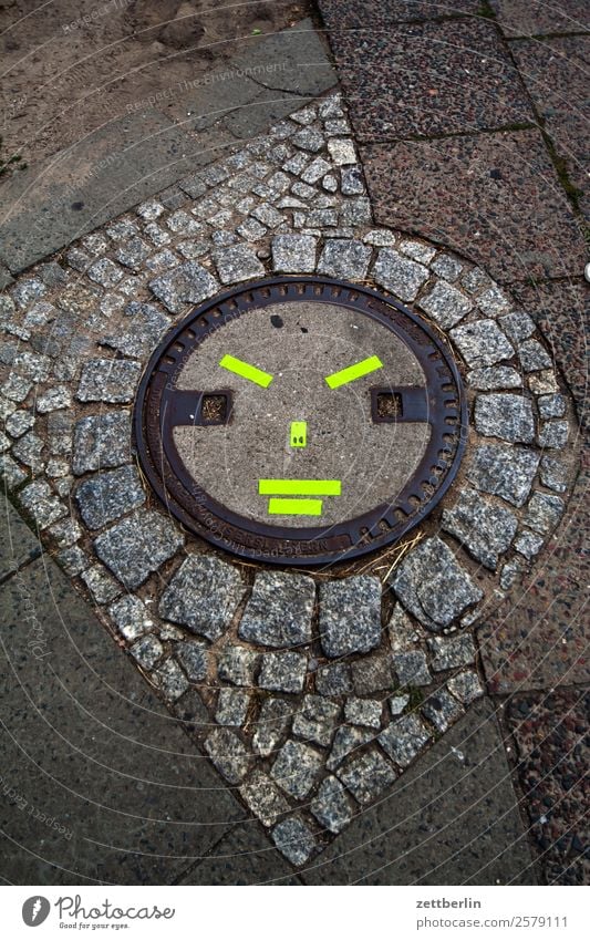 Manhole cover/Ninja Berlin City Germany Capital city Downtown Culture Town City life Street art Art Joy Creativity Mask Costume Carnival costume Face Evil