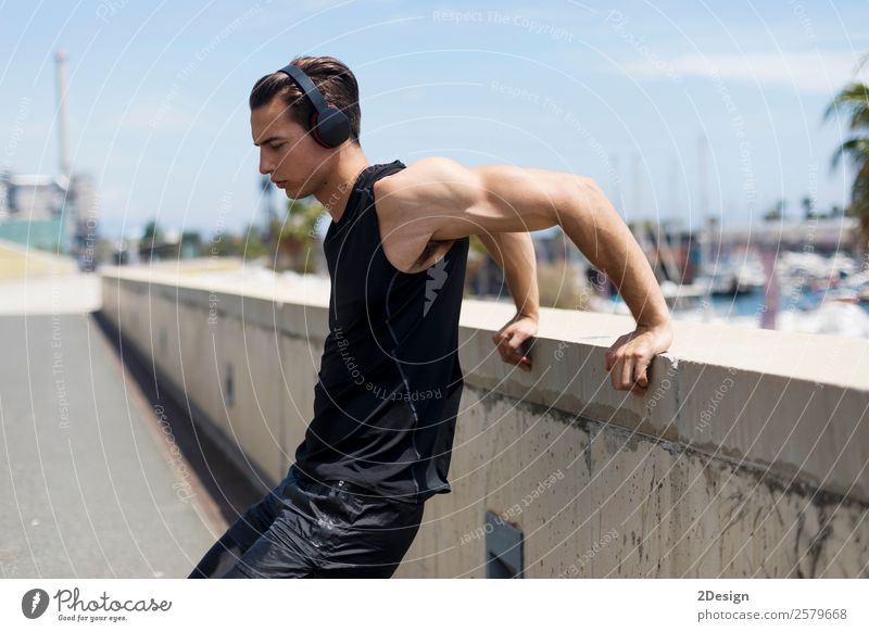 Muscular man stretching outdoors Lifestyle Body Relaxation Summer Sports Human being Masculine Man Adults Fitness Jump Strong Black Self-confident Power Effort