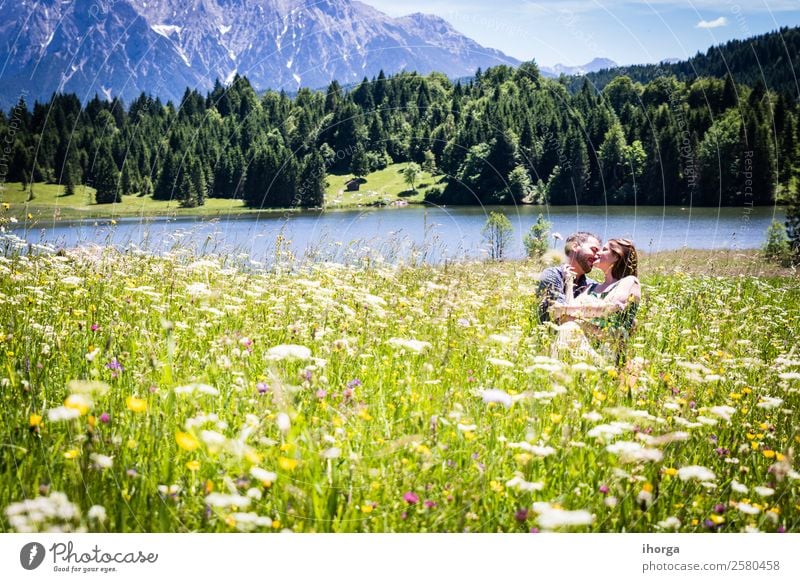 happy lovers on Holiday in the alps mountains adventure background beautiful cheerful countryside couple europe female field flower forest girl green hands