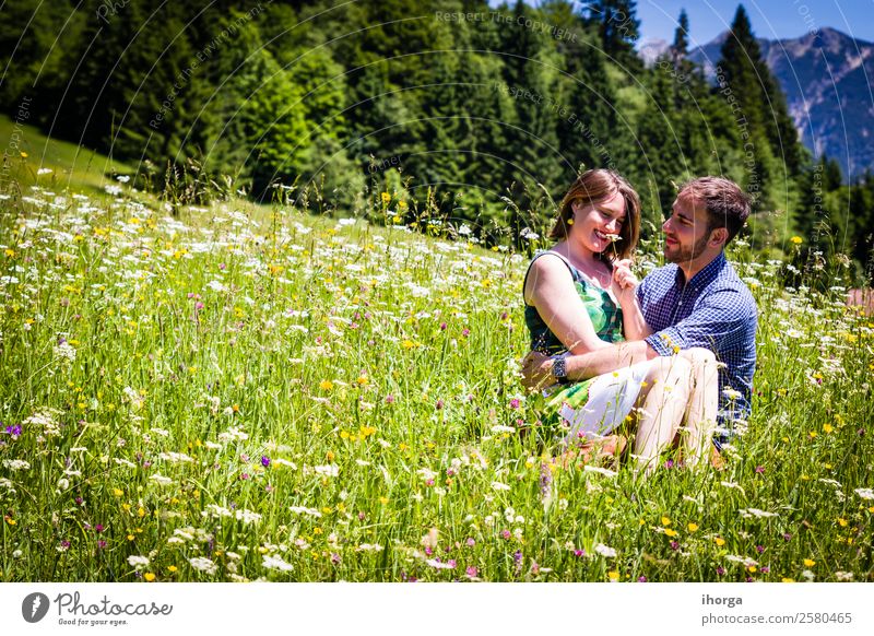 happy lovers on Holiday in the alps mountains adventure background beautiful cheerful countryside couple europe female field flower forest girl green hands