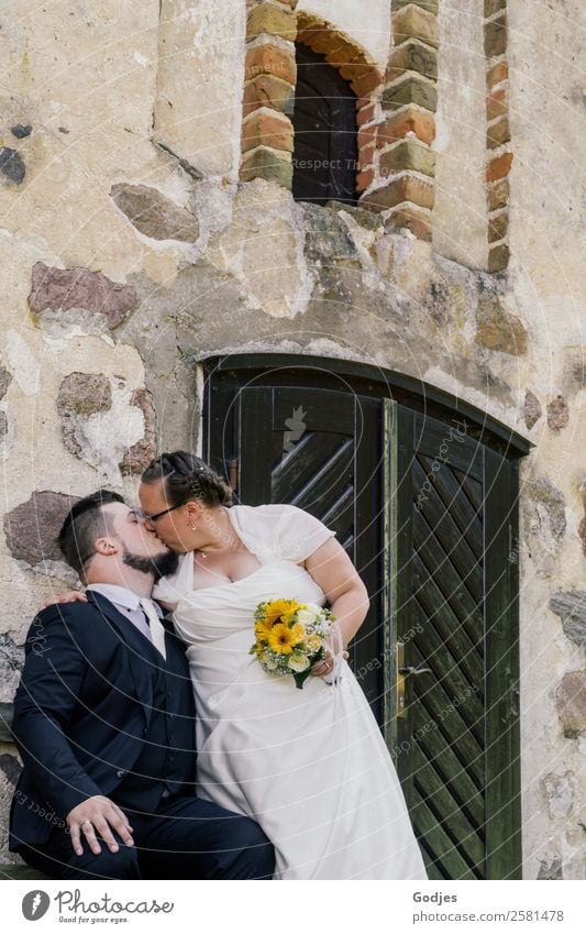 Bridal couple kisses in front of the church Wedding Human being Woman Adults Man Life 2 18 - 30 years Youth (Young adults) 30 - 45 years Plant Flower Sunflower