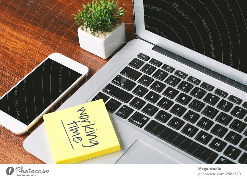 Office desk table with paper sheet with "working time" text. Clock Desk Table Work and employment Profession Workplace Business Telephone PDA Computer Notebook