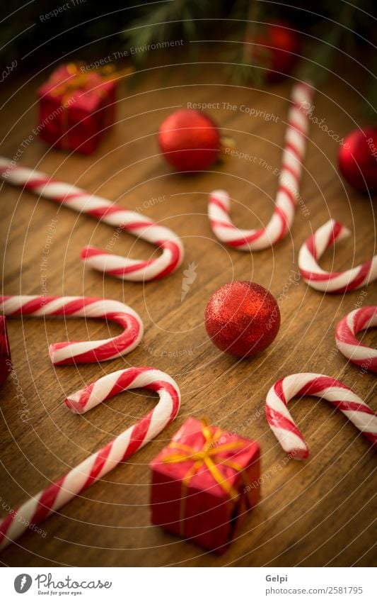 Candy canes with Christmas balls Dessert Design Joy Happy Winter Decoration Feasts & Celebrations Christmas & Advent Wood Ornament Stripe Bright Red White