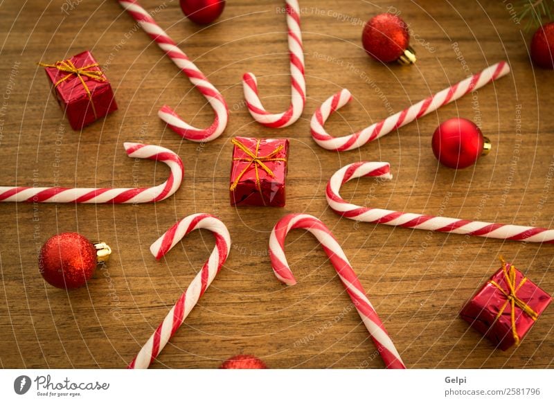 Candy canes with Christmas balls Dessert Design Joy Happy Winter Decoration Feasts & Celebrations Christmas & Advent Wood Ornament Stripe Bright Red White