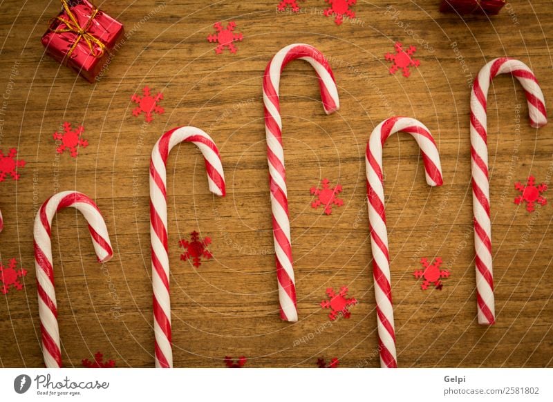 Candy canes with Christmas balls Dessert Design Joy Happy Winter Decoration Feasts & Celebrations Christmas & Advent Wood Ornament Stripe Bright Red White