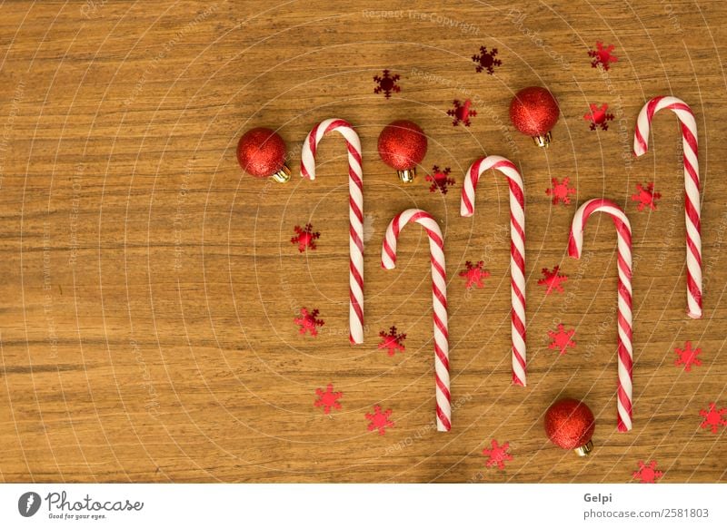 Candy canes with Christmas balls Dessert Design Joy Happy Winter Decoration Feasts & Celebrations Christmas & Advent Wood Ornament Stripe Bright Red White