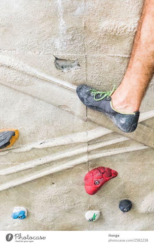 A Man practicing rock climbing on artificial wall indoors. Lifestyle Joy Leisure and hobbies Sports Climbing Mountaineering Adults Legs Feet 18 - 30 years