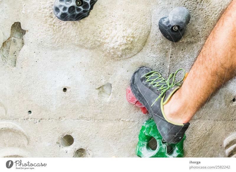 A Man practicing rock climbing on artificial wall indoors. Lifestyle Joy Leisure and hobbies Sports Climbing Mountaineering Adults Legs Feet 1 Human being