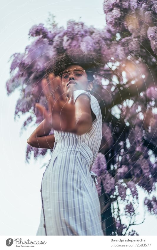 Happy young black woman surrounded by flowers Woman Blossom Spring Lilac Portrait photograph multiethnic Flower Black African Mixed race ethnicity Smiling