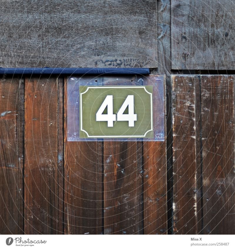 44 Wall (barrier) Wall (building) Door Digits and numbers Brown 40 House number Wooden wall Wooden board Colour photo Subdued colour Close-up Detail Pattern