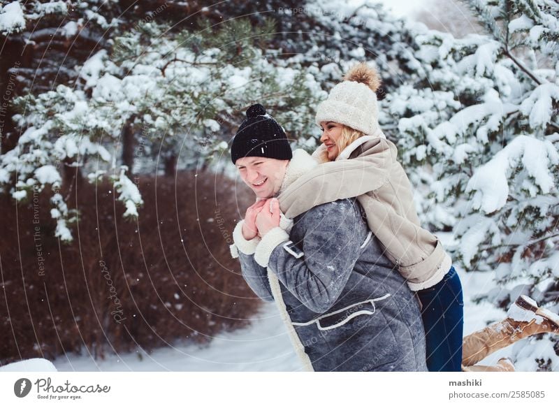 Lifestyle winter portrait of romantic couple walking Vacation & Travel Adventure Freedom Winter Snow Woman Adults Man Couple Nature Snowfall Park Forest Gloves