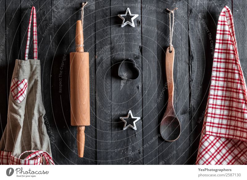 Kitchen utensils hang on a wooden wall Thanksgiving Christmas & Advent Gastronomy Family & Relations Wooden spoon Retro Red Black Apron Baking christmas