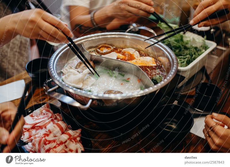 Korean hot pot and people taking food with chopsticks. Meat Seafood Vegetable Soup Stew Eating Pot Lifestyle Vacation & Travel Restaurant Human being Hand 3