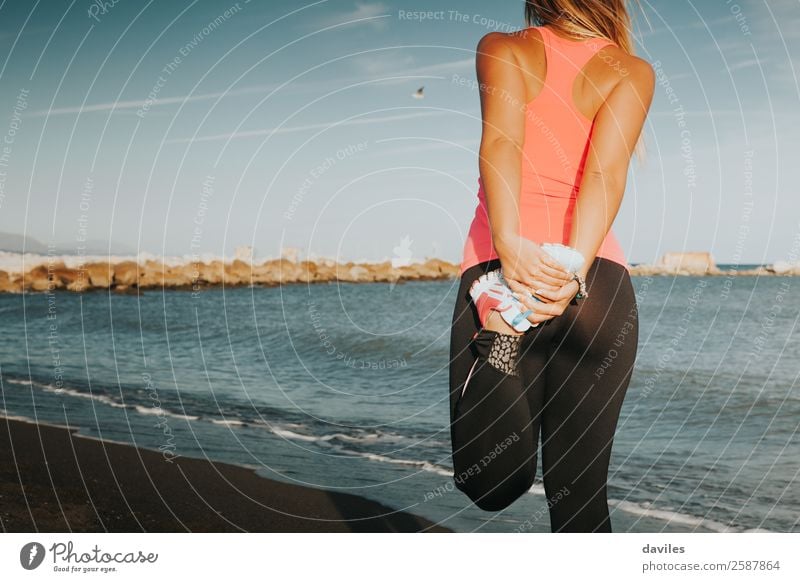 Sports girl stretching legs on the beach, with sea in the background. Lifestyle Body Summer Beach Ocean Fitness Sports Training Jogging Human being Feminine