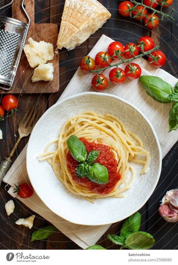 Spaghetti pasta with tomato sauce, basil and cheese Vegetable Herbs and spices Nutrition Lunch Dinner Vegetarian diet Plate Fork Spoon Restaurant Leaf Wood Dark