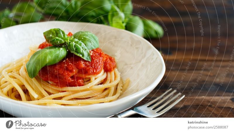 Spaghetti pasta with tomato sauce, basil and cheese Vegetable Herbs and spices Nutrition Lunch Dinner Vegetarian diet Plate Spoon Restaurant Leaf Wood Dark