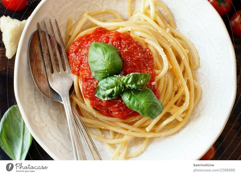 Spaghetti pasta with tomato sauce, basil and cheese Vegetable Herbs and spices Nutrition Lunch Dinner Vegetarian diet Plate Spoon Restaurant Leaf Wood Dark