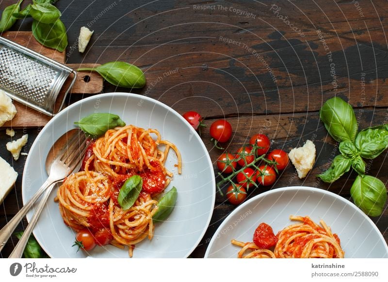 Spaghetti pasta with tomato sauce, basil and cheese Vegetable Herbs and spices Nutrition Lunch Dinner Vegetarian diet Plate Spoon Restaurant Leaf Wood Dark