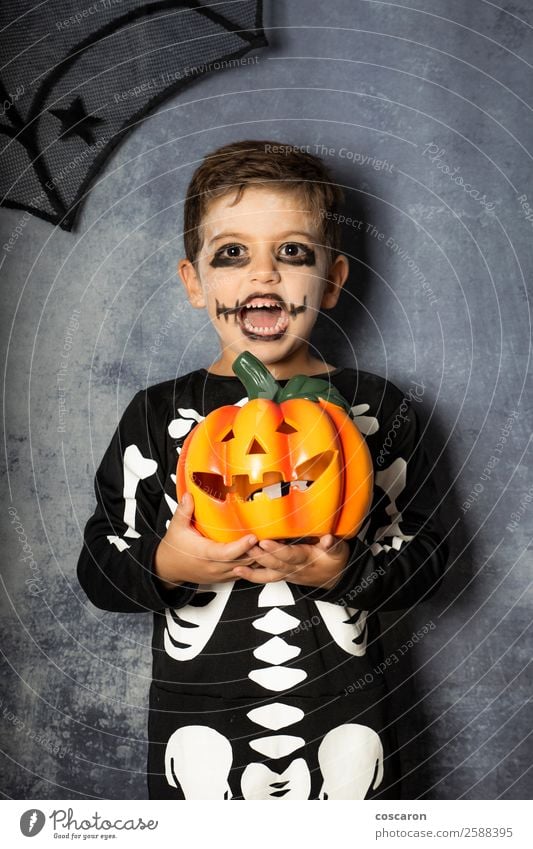 Young boy in the Skeleton costume holding Halloween pumpkin Joy Beautiful Face Life Decoration Feasts & Celebrations Carnival Hallowe'en Child Internet