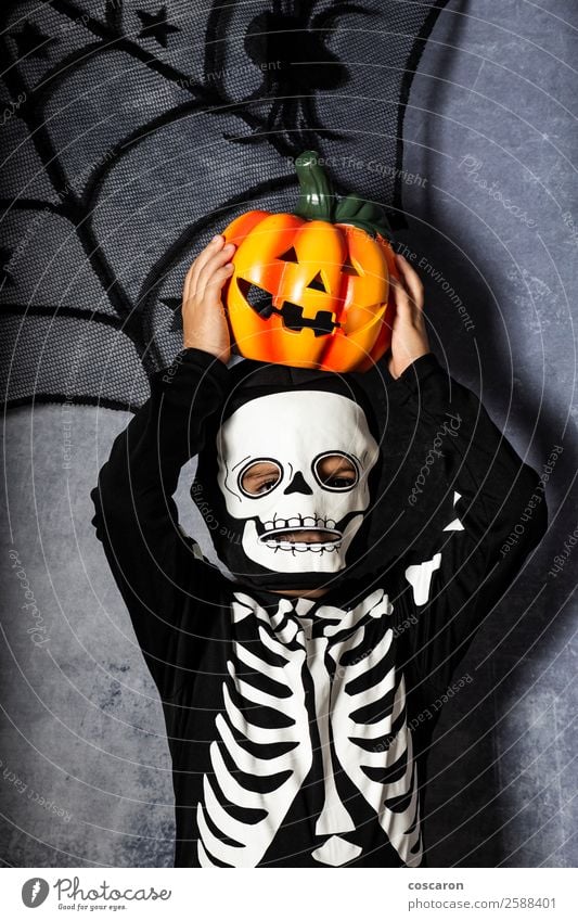 Young boy in the Skeleton costume holding Halloween pumpkin Joy Beautiful Face Mascara Life Decoration Feasts & Celebrations Carnival Hallowe'en Child Internet