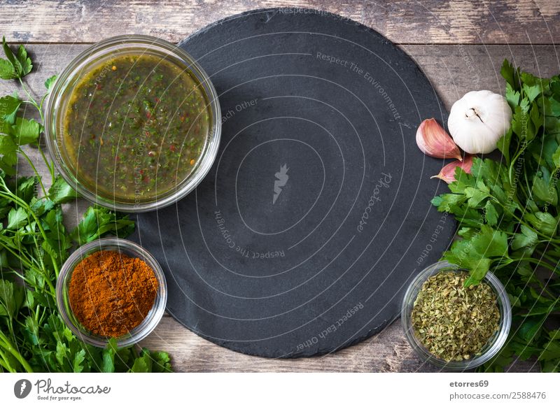 Green Chimichurri Sauce and ingredients on wooden background chimichurri Food Healthy Eating Food photograph Chili Aromatic Argentina Garlic Dish Home-made jar