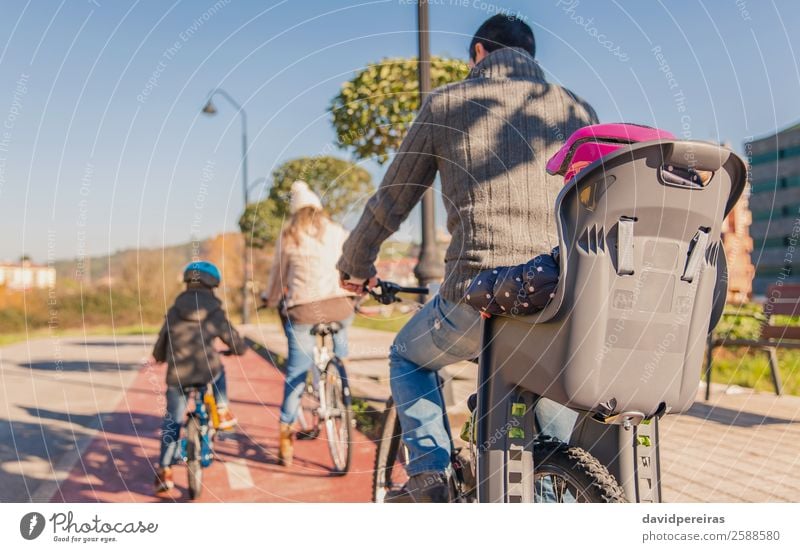 Family with children riding bicycles in the nature Lifestyle Joy Happy Leisure and hobbies Sun Winter Sports Child Baby Boy (child) Woman Adults Man Parents