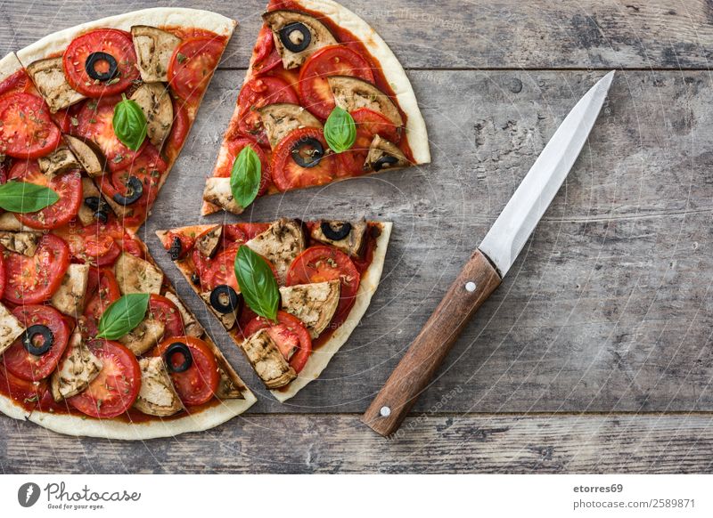 Vegetarian pizza slice Pizza Vegetarian diet Vegan diet Tomato Aubergine Oregano Basil Olive Food Healthy Eating Food photograph Dish Slice Wood Take Delicious